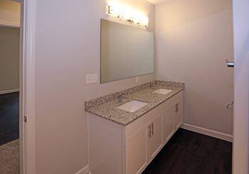 double vanity with granite countertops and undermount sinks at Promenade at Founders Square Apartments in Indianapolis, IN